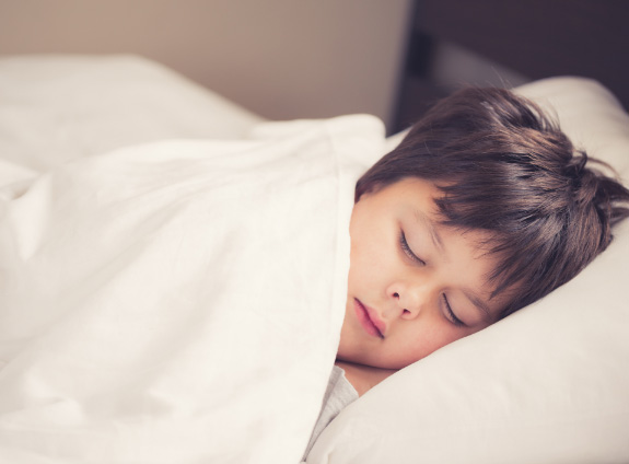 Little boy waking up refreshed thanks to HealthyStart treatment